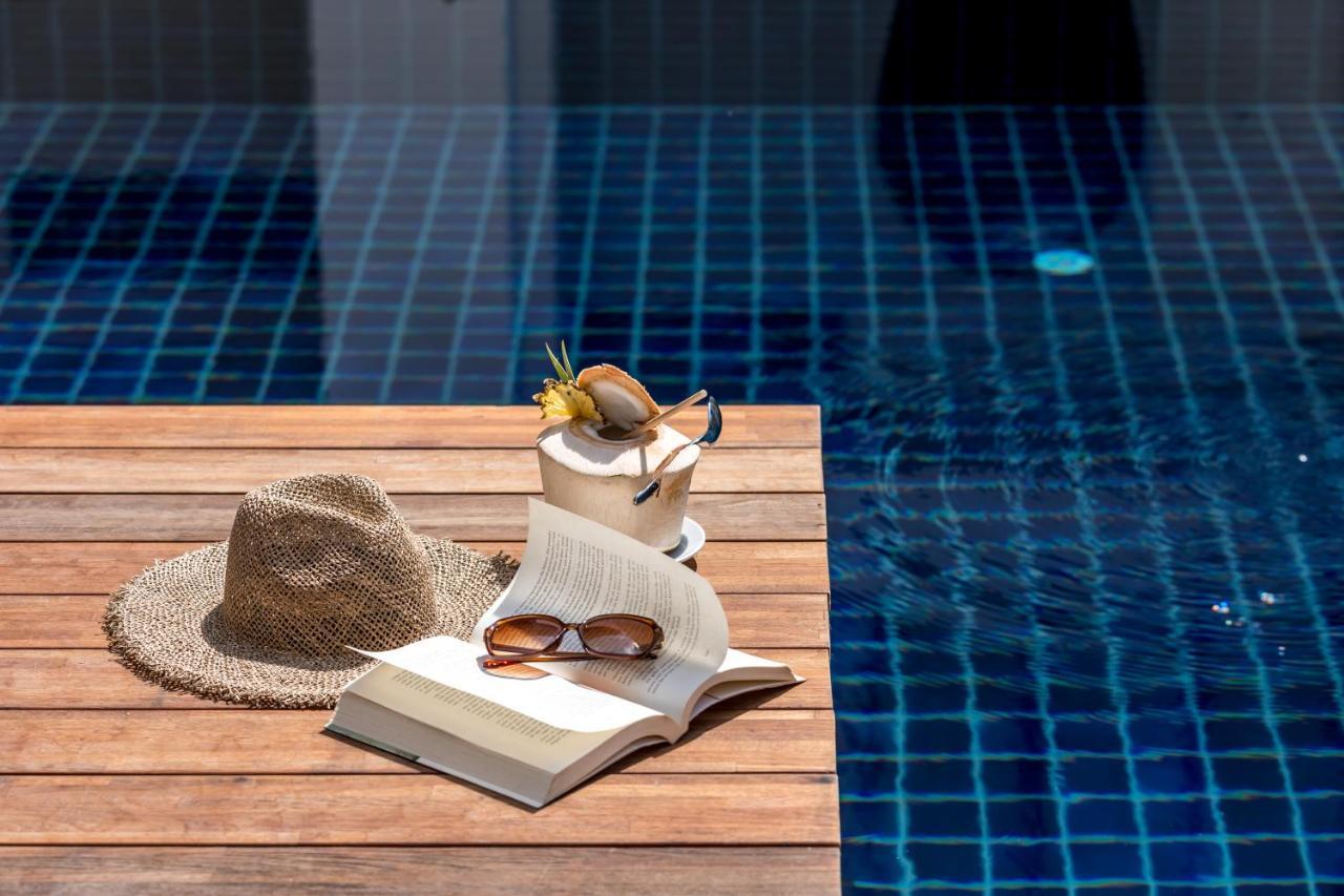 Outrigger Surin Beach Resort - Sha Extra Plus Εξωτερικό φωτογραφία A poolside table