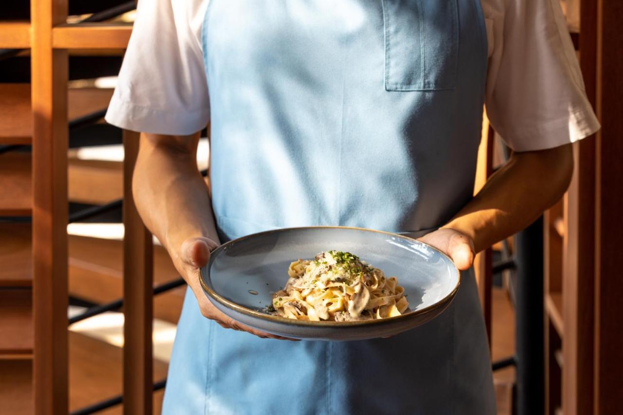 Outrigger Surin Beach Resort - Sha Extra Plus Εξωτερικό φωτογραφία A server holding a plate of pasta