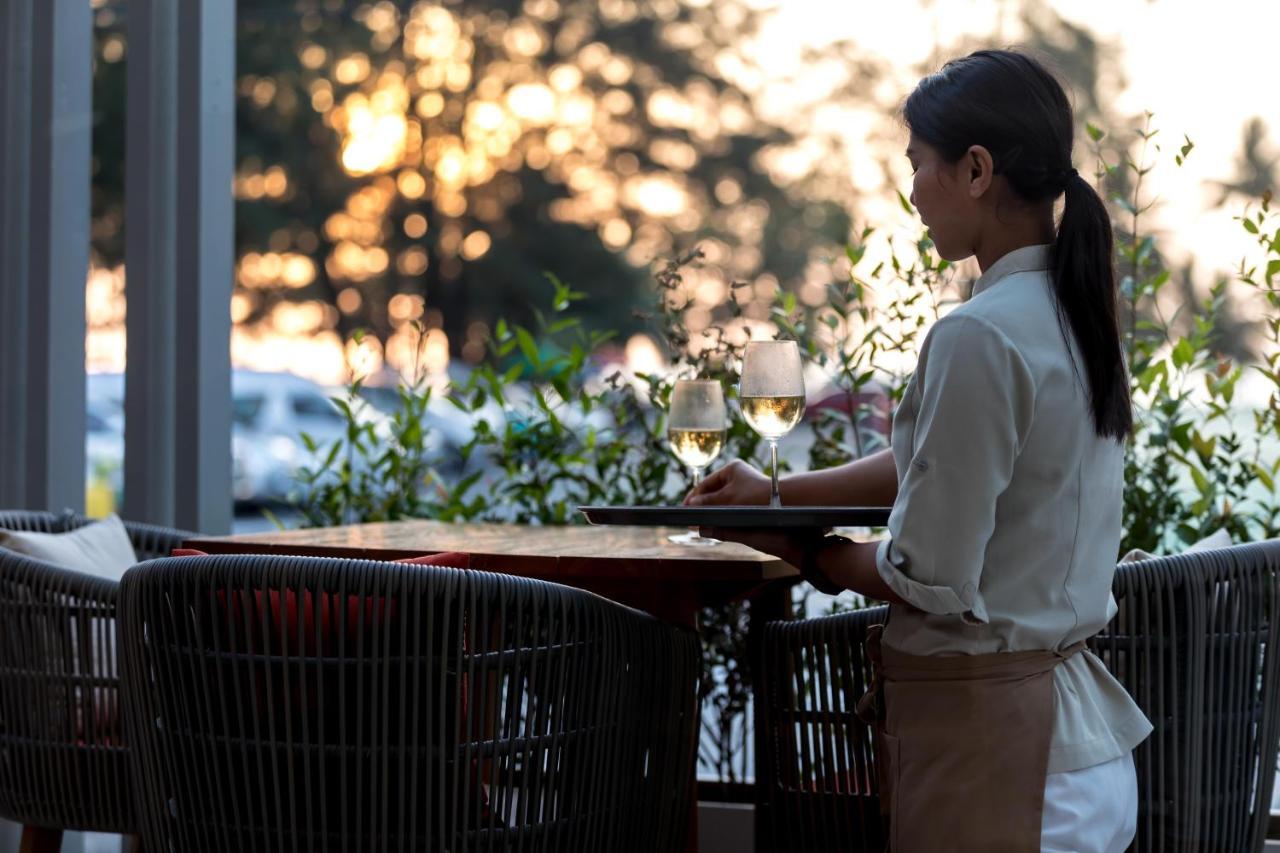 Outrigger Surin Beach Resort - Sha Extra Plus Εξωτερικό φωτογραφία A waitress clearing a table