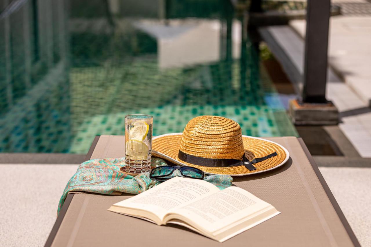 Outrigger Surin Beach Resort - Sha Extra Plus Εξωτερικό φωτογραφία A poolside table